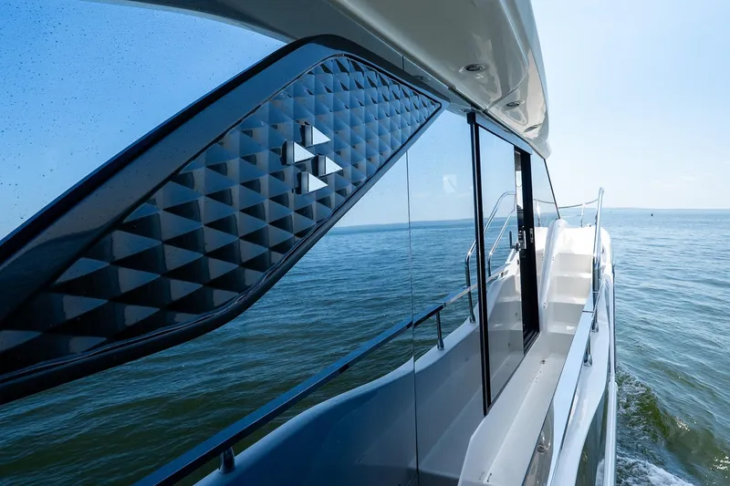 Slide: The Image of Prestige F5.7 yacht cruising on open water, showcasing sleek design, 2026 model. - 37