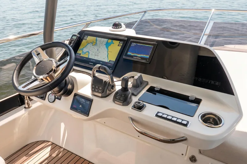 Slide: The Image of Helm of 2026 Prestige F5.7 yacht with navigation screens and controls. - 24