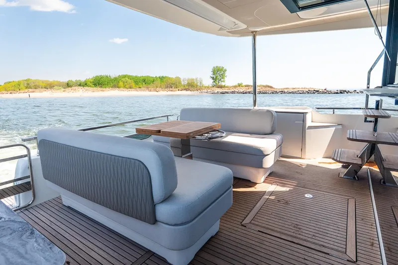 Slide: The Image of Luxurious Prestige F5.7 yacht interior, 2026 model, featuring elegant seating and scenic ocean view. - 41
