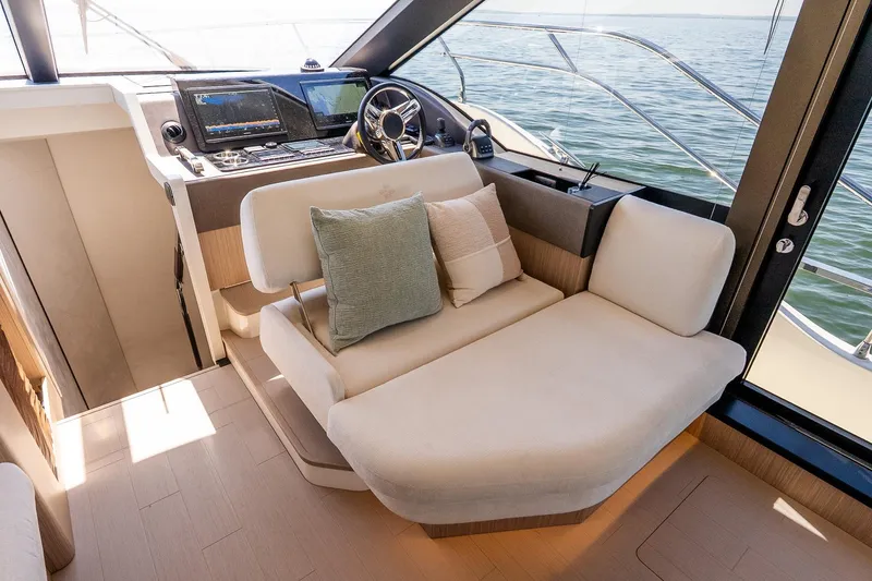 Slide: The Image of Luxurious interior of 2026 Prestige F5.7 yacht with plush seating and modern navigation controls. - 60