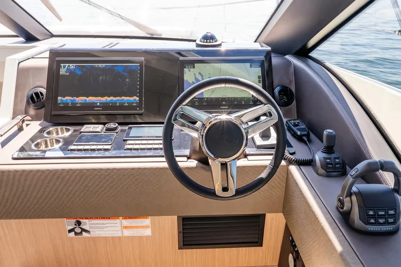 Slide: The Image of Helm of 2026 Prestige F5.7 yacht with advanced navigation displays and controls. - 63