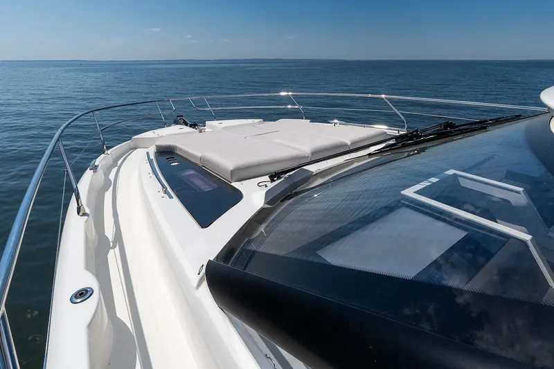 Slide: The Image of Prestige F5.7 yacht deck, 2026 model, cruising on open sea under clear blue sky. - 19