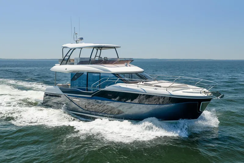 The Image of Luxurious 2026 Prestige F5.7 yacht cruising on open water under clear blue skies. - 0