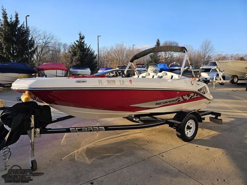 Slide: The Image of 2018 Scarab 165 ID boat on trailer in outdoor parking lot. - 12