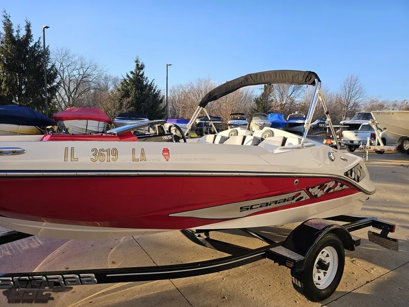 Slide: The Image of 2018 Scarab 165 ID boat with trailer, parked outdoors. - 14