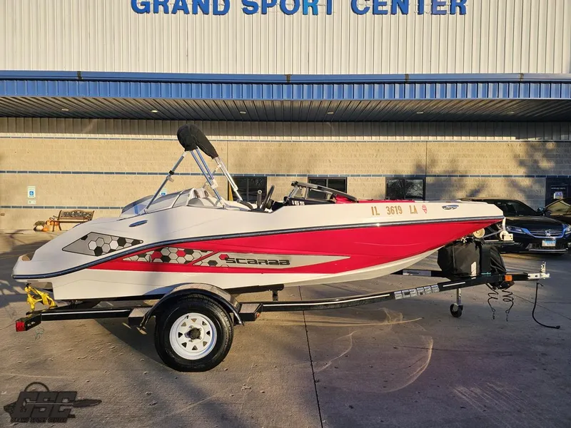 Slide: The Image of 2018 Scarab 165 ID boat with red accents at Grand Sport Center. - 2