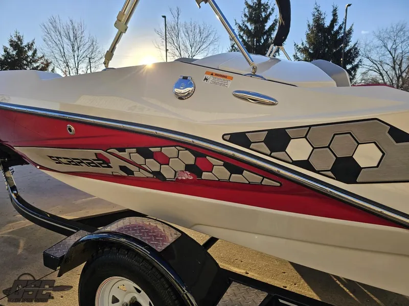 Slide: The Image of 2018 Scarab 165 ID boat with hexagonal design, parked on a trailer. - 20