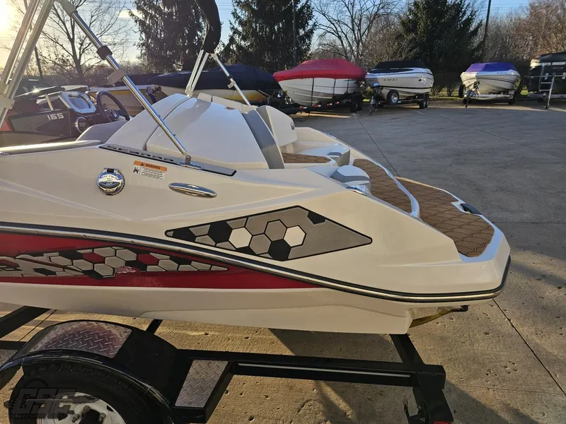 Slide: The Image of 2018 Scarab 165 ID boat with hexagonal design, parked on a trailer. - 21