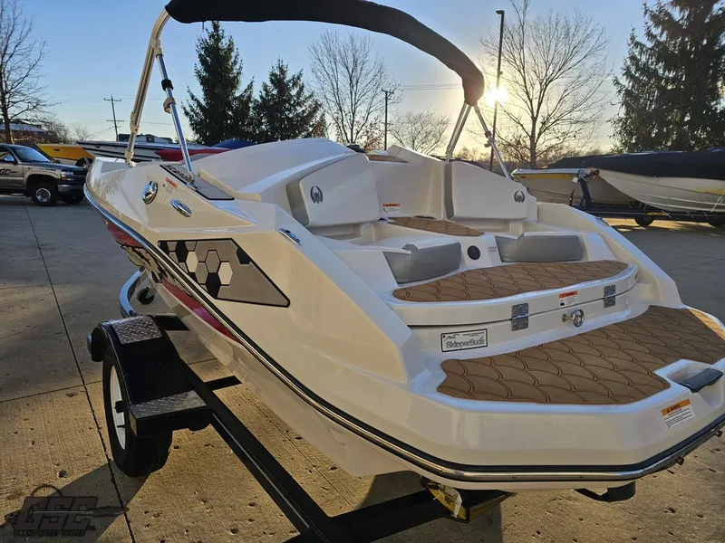 Slide: The Image of 2018 Scarab 165 ID boat on trailer, sunlit, with brown deck padding. - 23