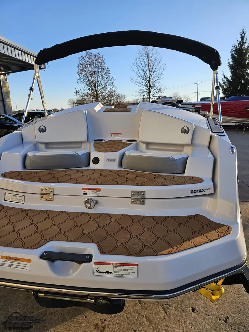 Slide: The Image of 2018 Scarab 165 ID boat with cushioned seating and Rotax engine, docked outdoors. - 26