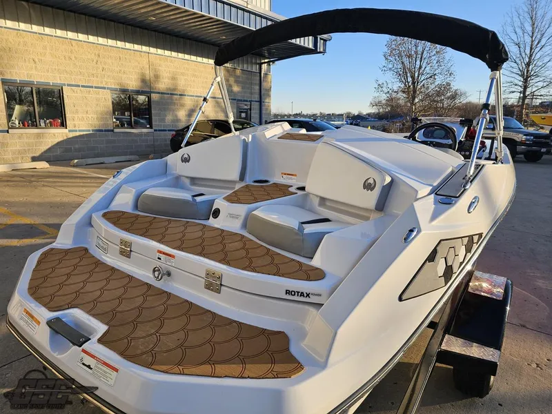 Slide: The Image of 2018 Scarab 165 ID boat with stylish seating and Rotax engine, parked outdoors. - 27