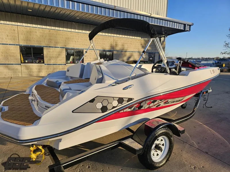 Slide: The Image of 2018 Scarab 165 ID boat on trailer, parked outside a building. - 28