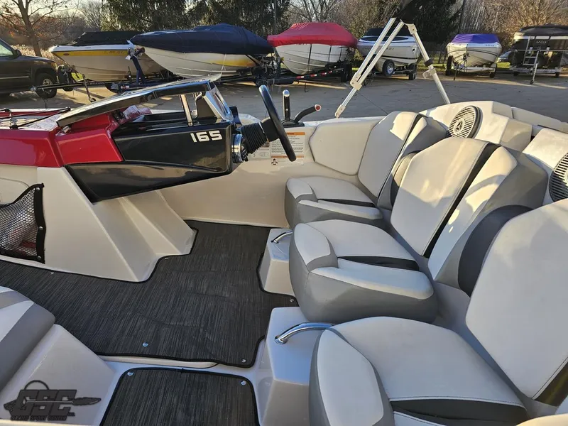 Slide: The Image of 2018 Scarab 165 ID boat interior with seating and steering wheel. - 35