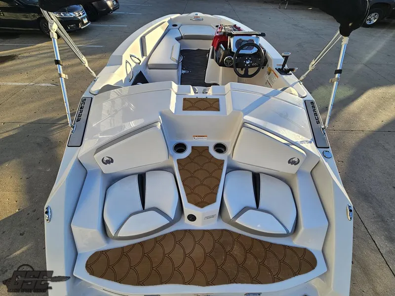 Slide: The Image of 2018 Scarab 165 ID boat interior with white seating and brown flooring. - 38