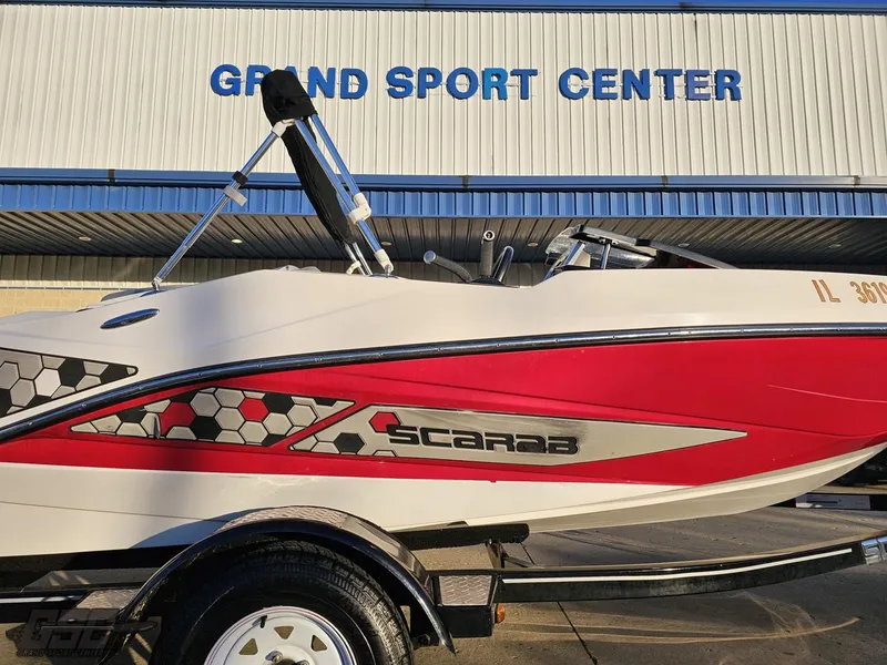 Slide: The Image of 2018 Scarab 165 ID boat at Grand Sport Center, featuring red and white design. - 4