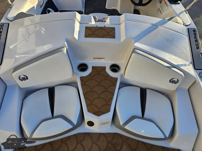 Slide: The Image of 2018 Scarab 165 ID boat interior with white seating and brown flooring. - 40
