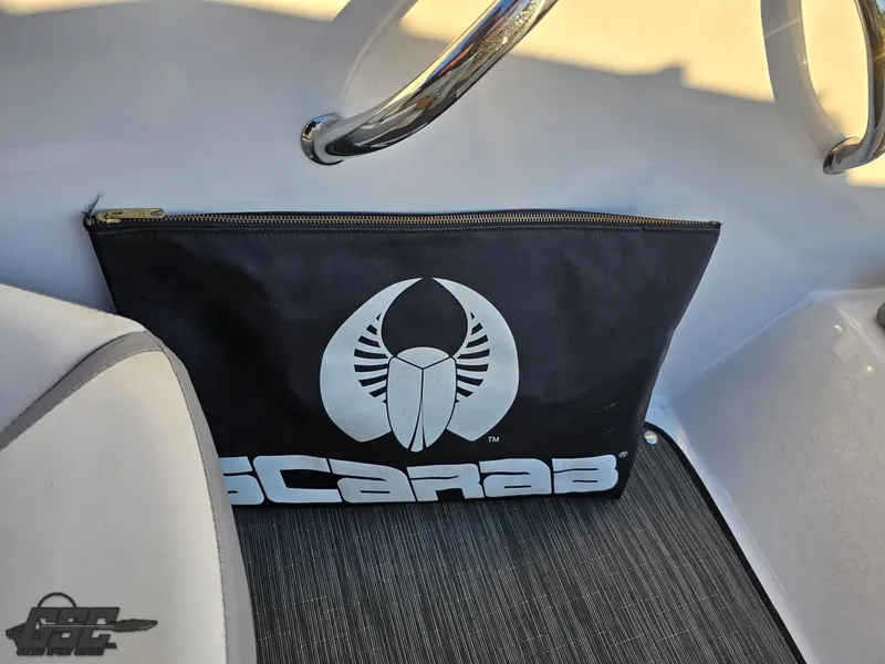 Slide: The Image of Scarab 165 ID 2018 boat interior with branded pouch and steering wheel. - 44