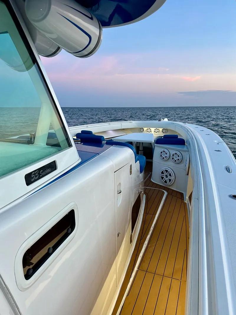 Slide: The Image of 2018 Hydra-Sports 5300 Suenos boat on open water at sunset. - 12