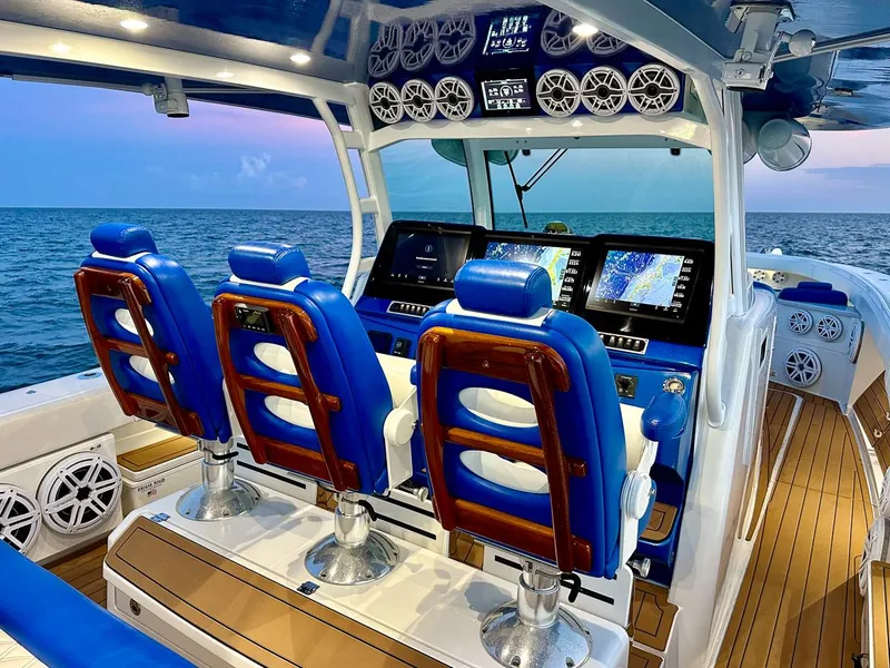 Slide: The Image of 2018 Hydra-Sports 5300 Suenos boat interior with blue seating and advanced navigation systems. - 4