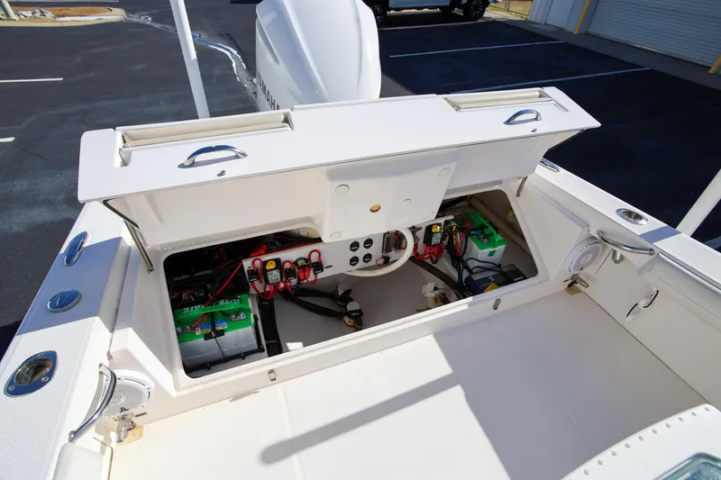 Slide: The Image of Open battery compartment of 2017 Everglades 253 Center Console boat, showcasing wiring and components. - 12