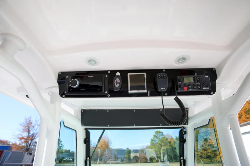 Slide: The Image of 2017 Everglades 253 Center Console boat dashboard with radio and navigation equipment. - 17