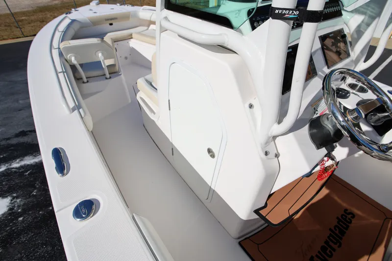 Slide: The Image of 2017 Everglades 253 Center Console boat interior with steering wheel and seating. - 18