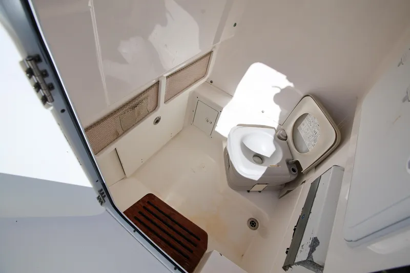 Slide: The Image of Interior of 2017 Everglades 253 Center Console boat with compact marine toilet. - 19