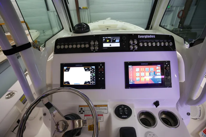 Slide: The Image of 2017 Everglades 253 Center Console dashboard with Simrad displays and controls. - 27