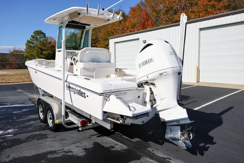 Slide: The Image of 2017 Everglades 253 Center Console boat with Yamaha engine, parked outdoors. - 4