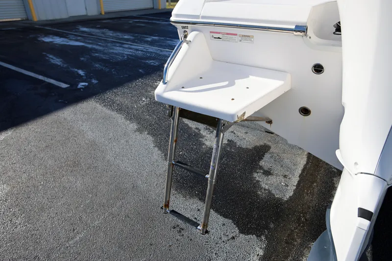 Slide: The Image of 2017 Everglades 253 Center Console boat ladder and platform on asphalt surface. - 8