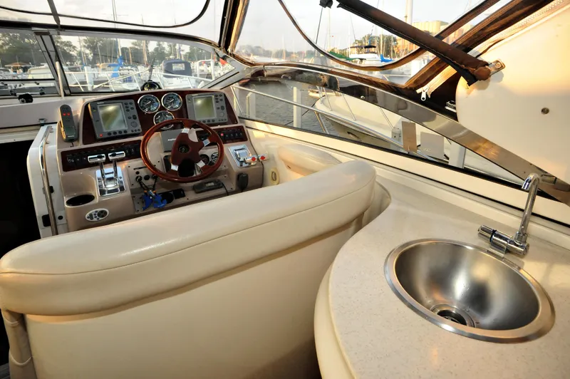Slide: The Image of Interior of 2001 Regal Commodore 4160 yacht with steering wheel and sink. - 12