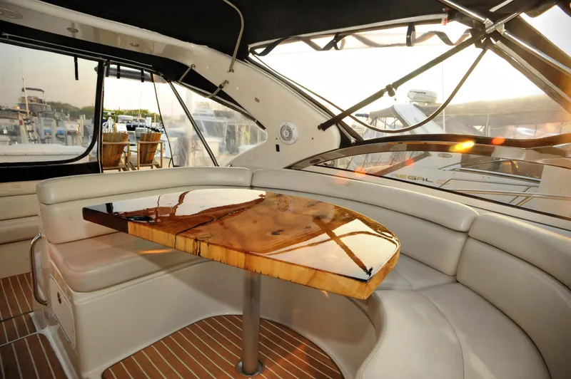 Slide: The Image of Luxurious interior of 2001 Regal Commodore 4160 yacht with elegant wooden table. - 13