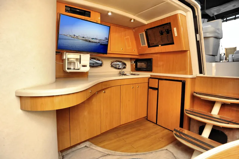 Slide: The Image of Interior of 2001 Regal Commodore 4160 yacht with kitchenette and TV. - 15