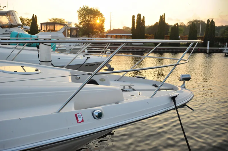 Slide: The Image of 2001 Regal Commodore 4160 yacht docked at sunset, reflecting on calm water. - 2