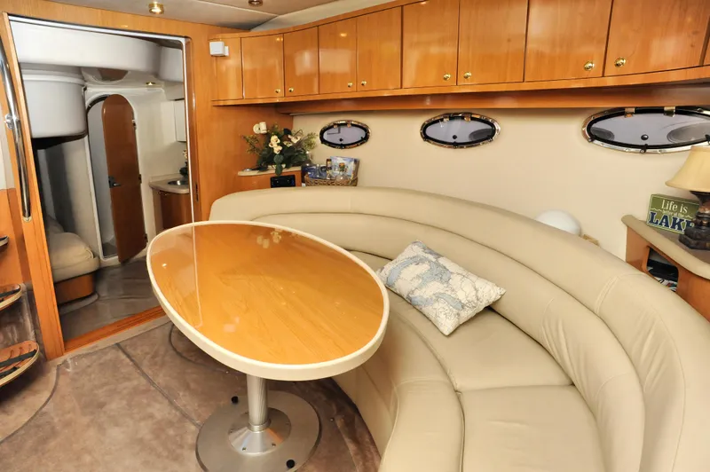 Slide: The Image of Luxurious interior of 2001 Regal Commodore 4160 yacht with curved seating and wooden table. - 20