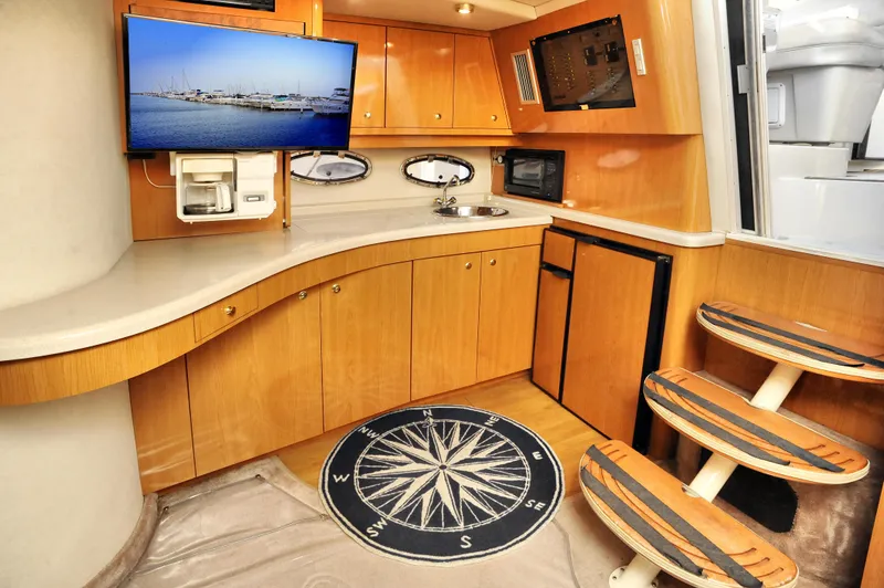 Slide: The Image of Interior of 2001 Regal Commodore 4160 yacht with kitchenette and TV. - 25