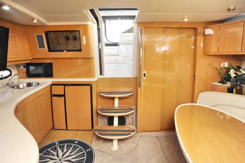 Slide: The Image of Interior of 2001 Regal Commodore 4160 yacht with wooden cabinetry and modern amenities. - 26