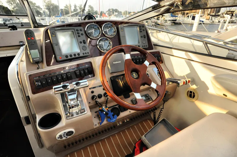 Slide: The Image of 2001 Regal Commodore 4160 helm with steering wheel, gauges, and navigation equipment. - 27