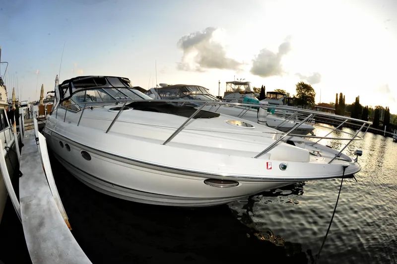 Slide: The Image of 2001 Regal Commodore 4160 yacht docked at sunset, reflecting on calm water. - 32