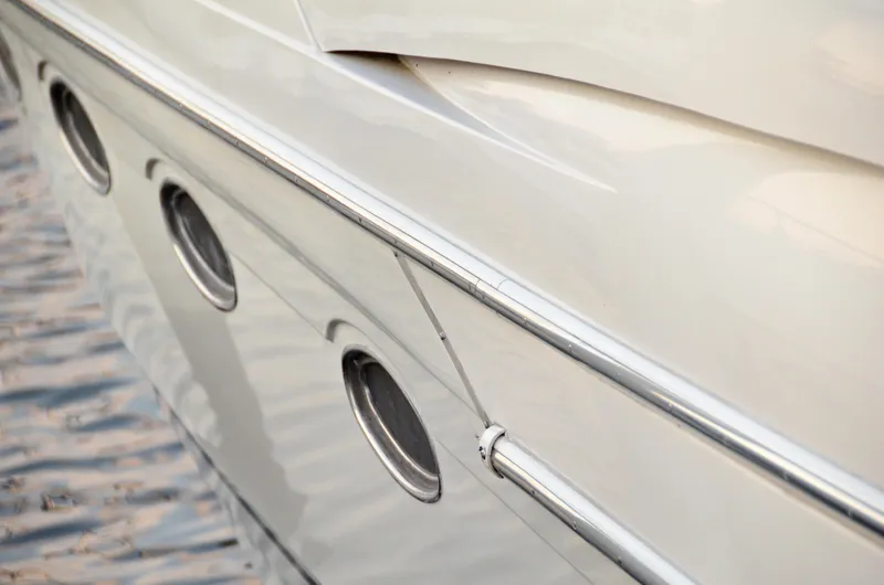 Slide: The Image of Close-up of 2001 Regal Commodore 4160 yacht with portholes and sleek design. - 4