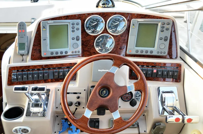 Slide: The Image of 2001 Regal Commodore 4160 boat dashboard with steering wheel and navigation instruments. - 6