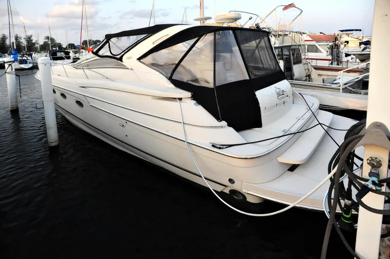 Slide: The Image of 2001 Regal Commodore 4160 yacht docked at marina, featuring sleek design and black canopy. - 7