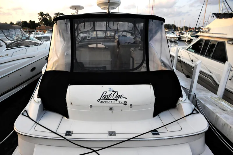 Slide: The Image of 2001 Regal Commodore 4160 yacht docked at marina, rear view with cover. - 8