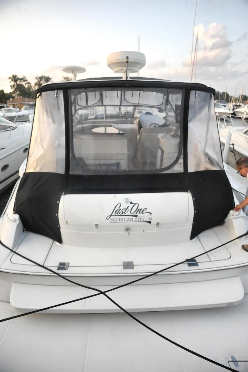 Slide: The Image of 2001 Regal Commodore 4160 yacht with black canopy docked at marina. - 9