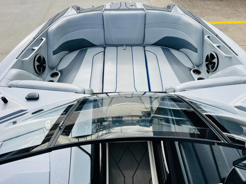 Slide: The Image of 2020 Malibu Wakesetter 24 MXZ boat interior with sleek gray seating and modern design. - 10