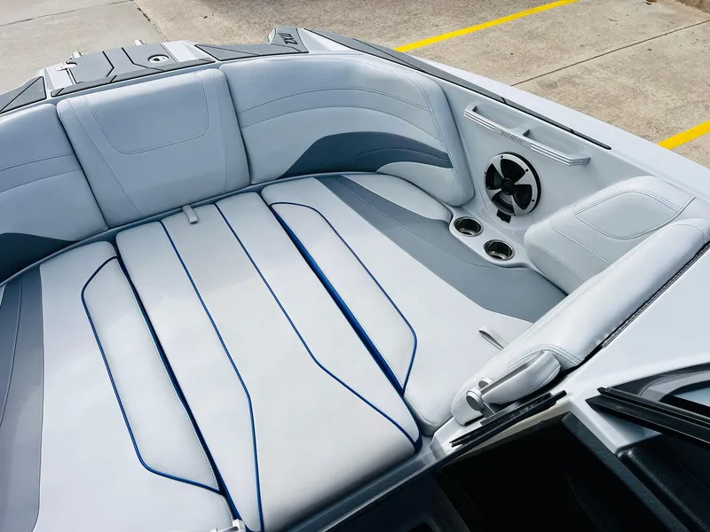 Slide: The Image of 2020 Malibu Wakesetter 24 MXZ interior with sleek seating and built-in speakers. - 12