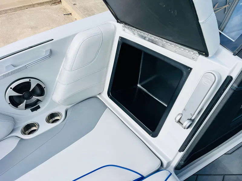 Slide: The Image of 2020 Malibu Wakesetter 24 MXZ interior with storage compartment and speaker. - 15
