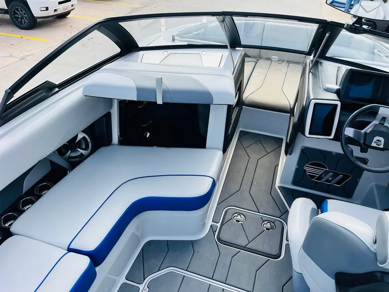 Slide: The Image of 2020 Malibu Wakesetter 24 MXZ interior with sleek seating and modern dashboard design. - 19