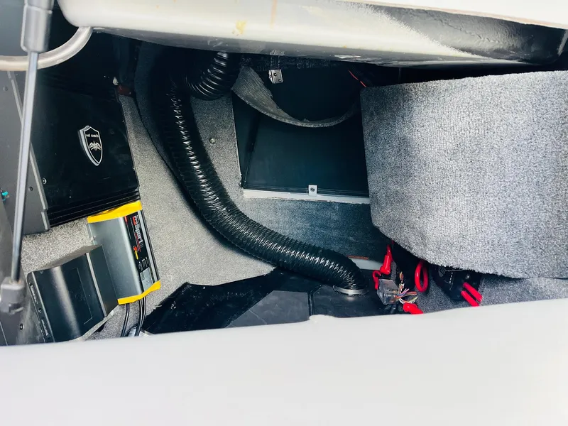 Slide: The Image of 2020 Malibu Wakesetter 24 MXZ interior compartment with wiring and components. - 20