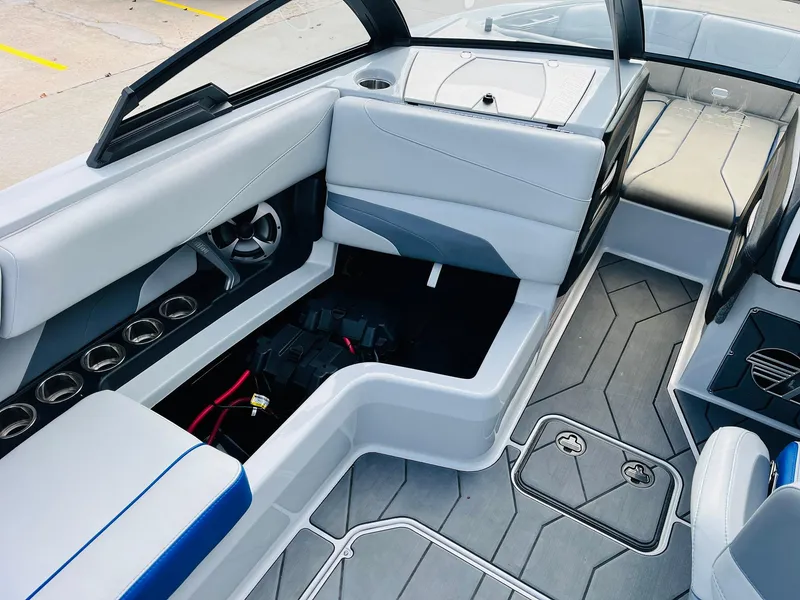Slide: The Image of 2020 Malibu Wakesetter 24 MXZ interior with seating and storage compartments. - 21